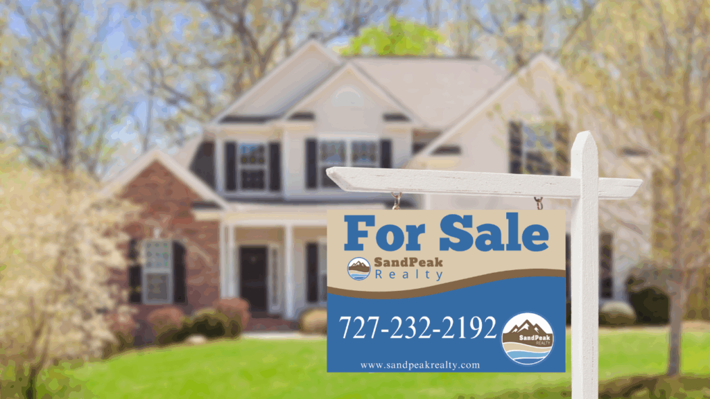 Home with a SandPeak Realty for Sale sign with the phone number 7272322192